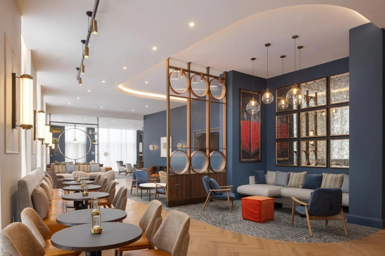 a restaurant with tables and couches and chairs at Residence Inn by Marriott Belfast Titanic Quarter in Belfast