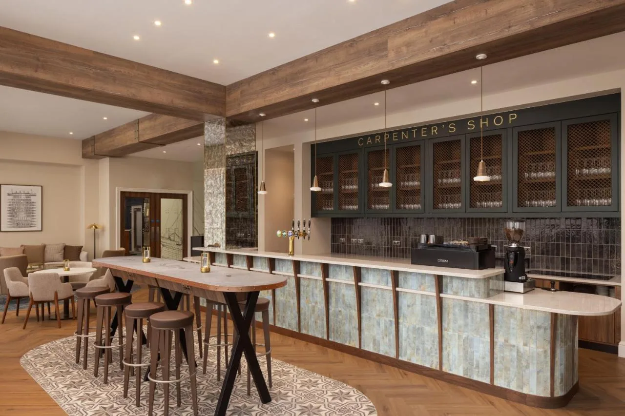 a bar in a restaurant with tables and chairs at Residence Inn by Marriott Belfast Titanic Quarter in Belfast